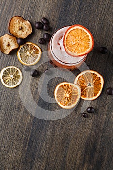 Orange cocktail with citron on wooden background