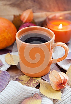 Orange coffee cup on the autumn fall leaves