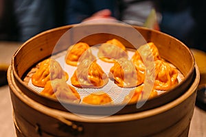 Orange color Foie Gras Xiao Long Bao Chinese Soup Dumpling in bamboo streamer