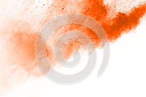 Orange color powder explosion on white background.