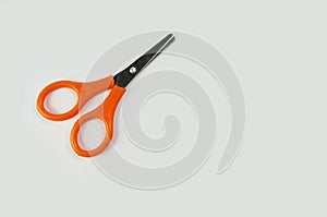 Orange color scissors isolated on white background.