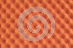 Orange colored egg crate foam sheet packing material background.