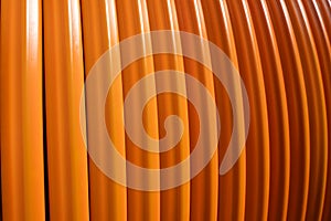 Orange colored fiber optic cable for laying in underground