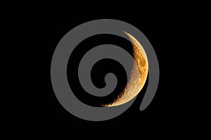 Orange colored waxing crescent moon