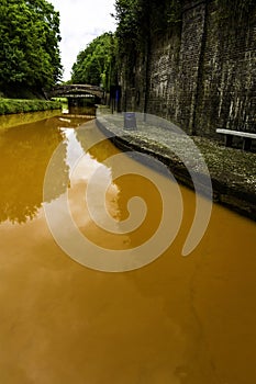 Orange coloured canal from clay in tunnel, The Trent and Mersey Canal