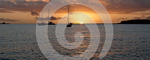 Orange Coloured Sunrise Seascape with yachts at anchor. Australia