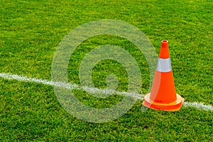 Orange cone on grass field