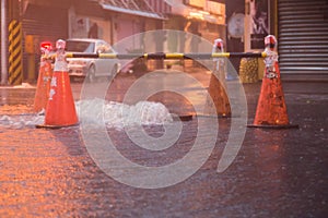 Orange cones around overflowing manhole