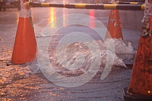 Orange cones around overflowing manhole