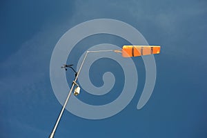 Orange conical windsock and wind cone photo