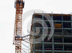 Orange construction crane near building site