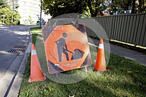 Orange Construction Sign with Stylized Man Digging