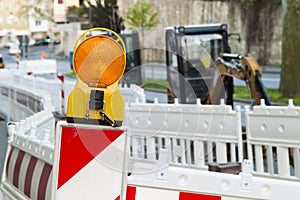 Orange construction Street barrier light on barricade. Road cons