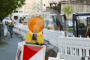 Orange construction Street barrier light on barricade. Road cons