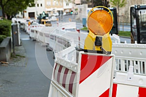 Orange construction Street barrier light on barricade. Road cons