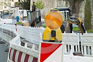 Orange construction Street barrier light on barricade. Road cons