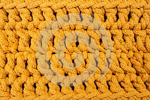 Orange cotton cord crochet pattern, abstract texture background, soft focus close up