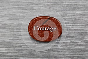 Orange Courage mood stone, on gray background
