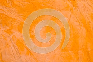 Orange creased colored tissue paper background texture