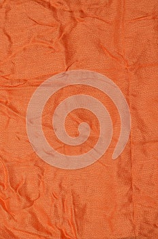 Orange crumpled textile background