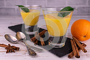 Orange curd with cinnamon on a light background