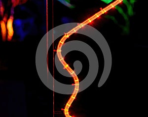 an orange curved led tube at night