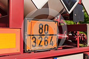 Orange dangerous goods sign on a truck