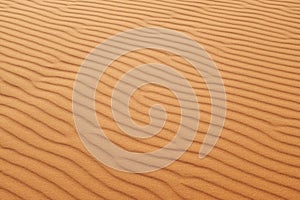 Orange desert sand ripples of the Arabian Desert for a warm summer background