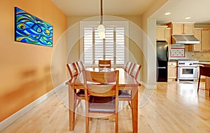 Orange dining room with hardwood