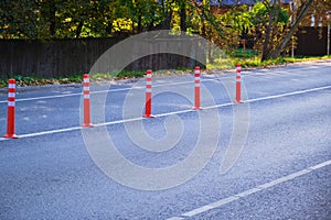 Orange dividing posts on the road. Selective focus