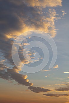 Orange dramatic sunset clouds over blue sky