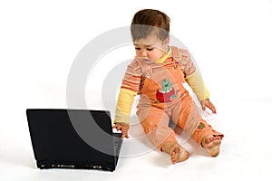 Orange dressed astonished boy working on laptop