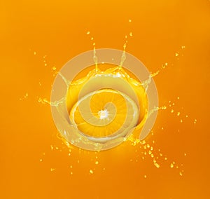 Orange drop in splashing orange juice