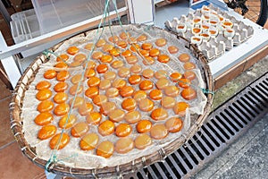 Orange duck egg yolks in winnow basket, Tai O village, Hong Kong