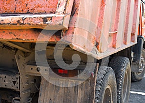 Orange dump truck. Rear view