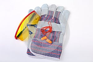 Orange earplug, safety glasses and gloves for work. Earplug to reduce noise on a white background.