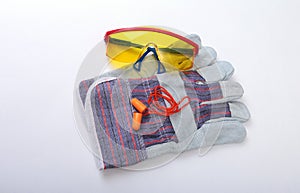 Orange earplug, safety glasses and glovs. Earplug to reduce noise on a white background .