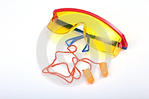Orange earplug and safety glasses for work. Earplug to reduce noise on a white background .