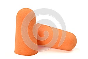 Orange earplugs highlighted on a white background.Close-up.Soft foam earplug