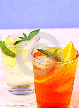 Orange, elderflower cocktails on blue background