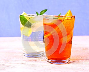 Orange and elderflower cocktails on blue background