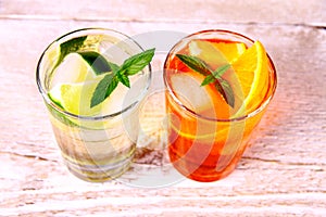 Orange and elderflower cocktails on white wooden background