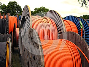 Orange electricity cable on wooden spools