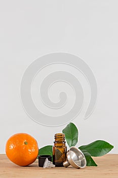 Orange Essential Oil Bottle With Black Cap, Citrus Leaves and Funnel