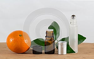 Orange Essential Oil Bottle With Black Cap, Citrus Leaves and Roller Bottle