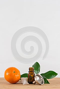 Orange Essential Oil Bottle With White Cap, Citrus Leaves and Funnel