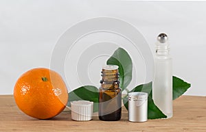 Orange Essential Oil Bottle With White Cap, Citrus Leaves and Roller Bottle