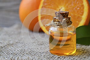 Orange essential oil in a glass bottle for skin care, spa, wellness, massage, aromatherapy and natural medicine.