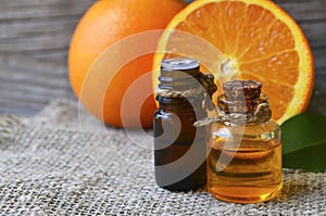 Orange essential oil in a glass bottles for skin care, spa, wellness, massage, aromatherapy and natural medicine.