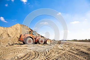 Orange excavator on a construction site